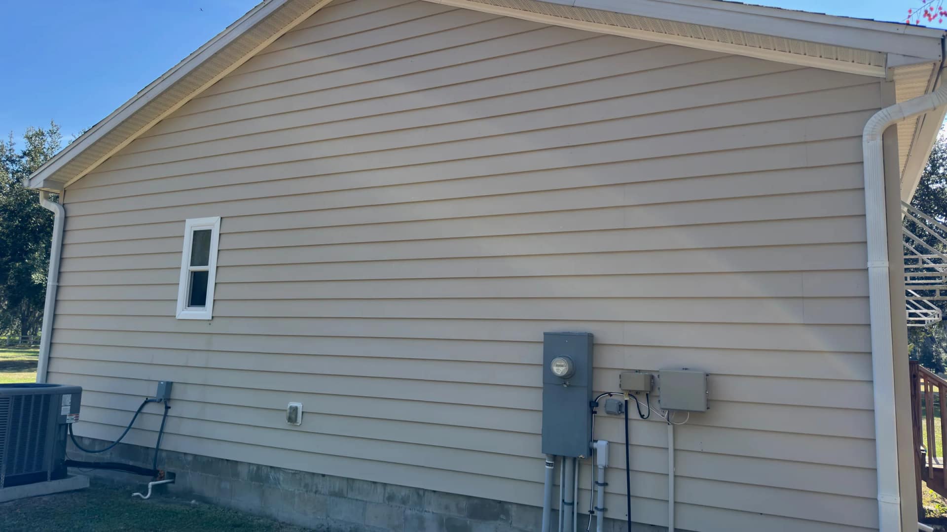 Same house siding after exterior cleaning removed visible staining before an insurance inspection