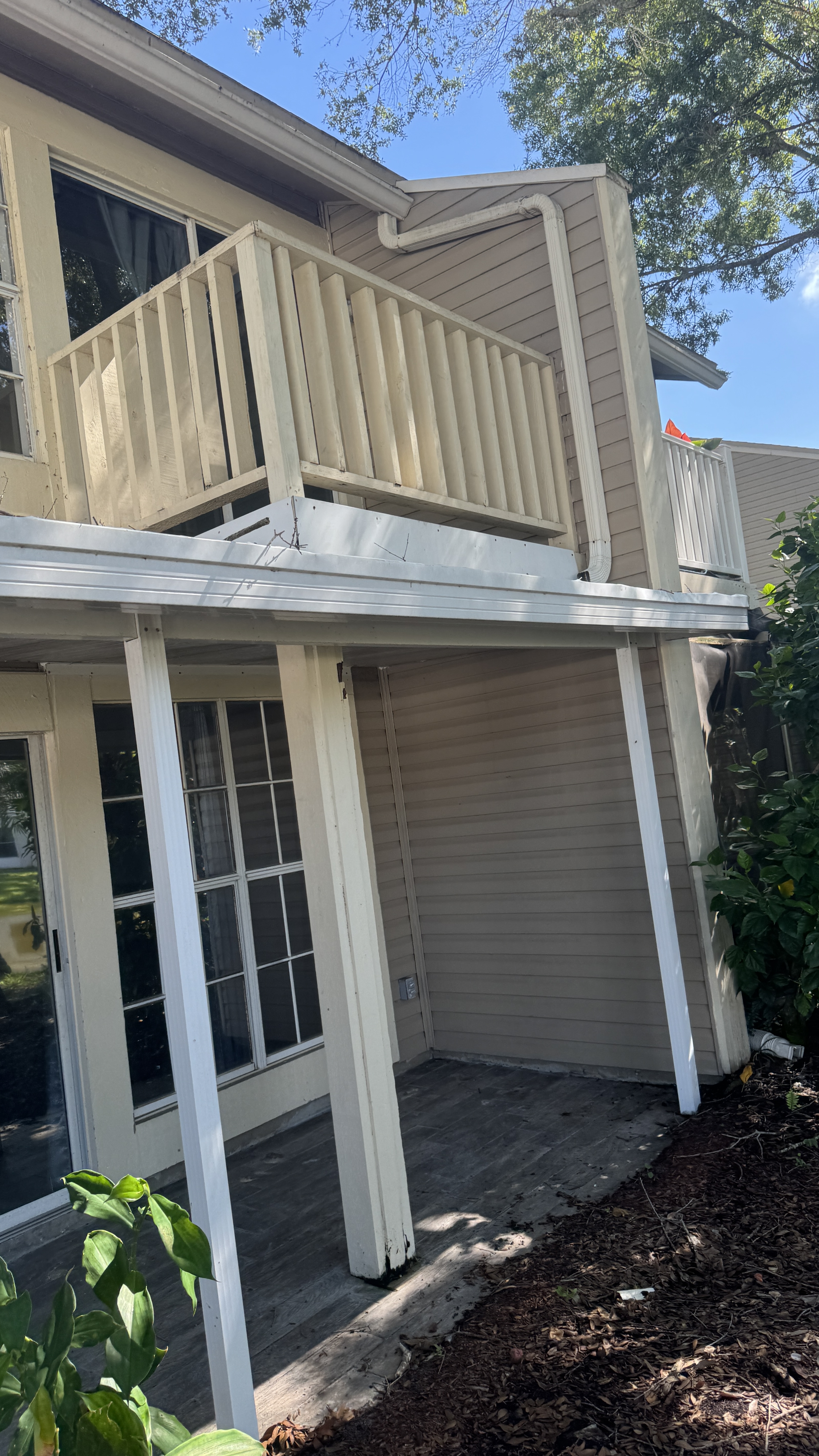 Gutter cleaning service in Tampa on a two-story home with visible roofline and gutter access