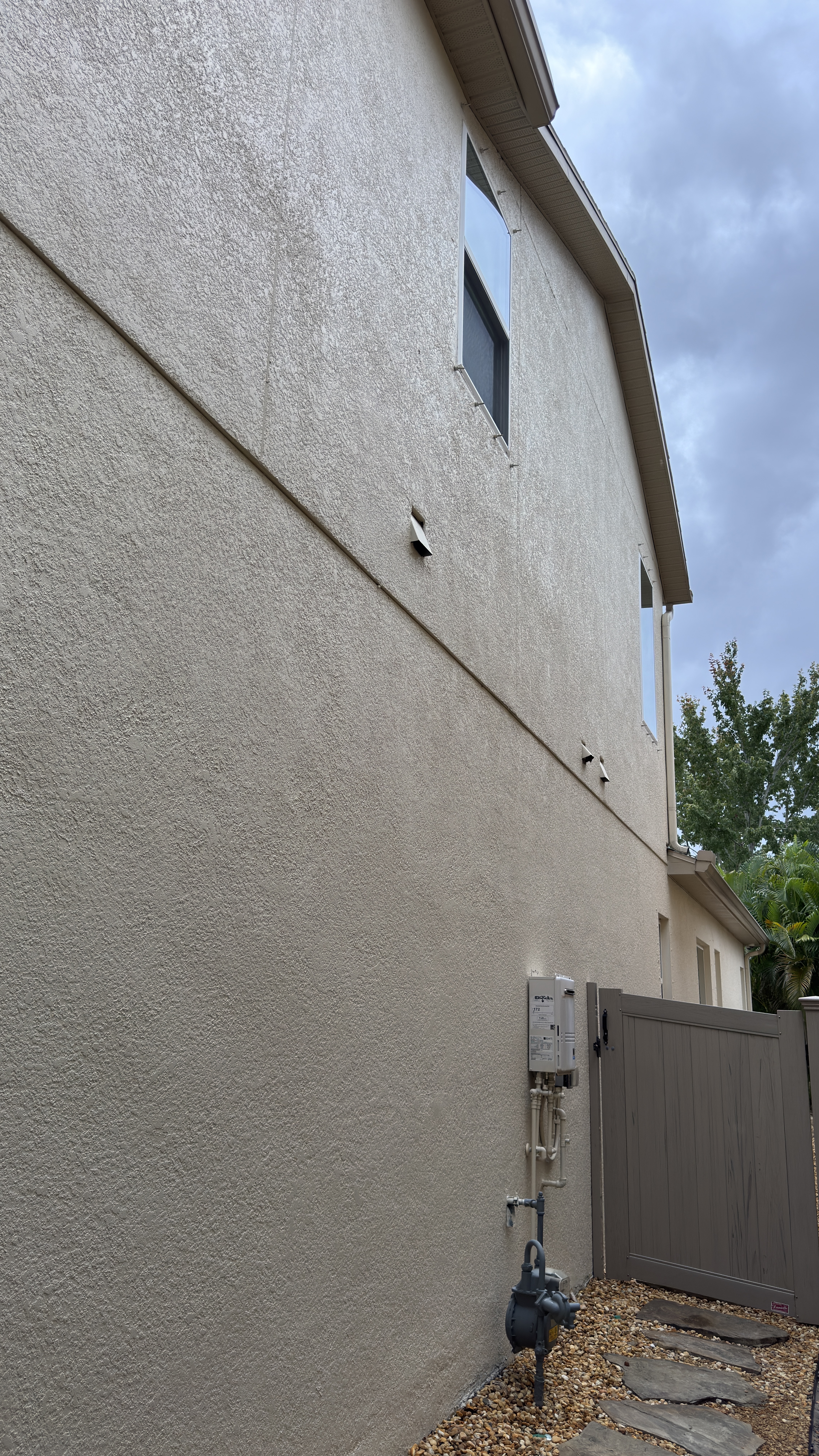 Stucco cleaning service in Tampa on a residential exterior wall