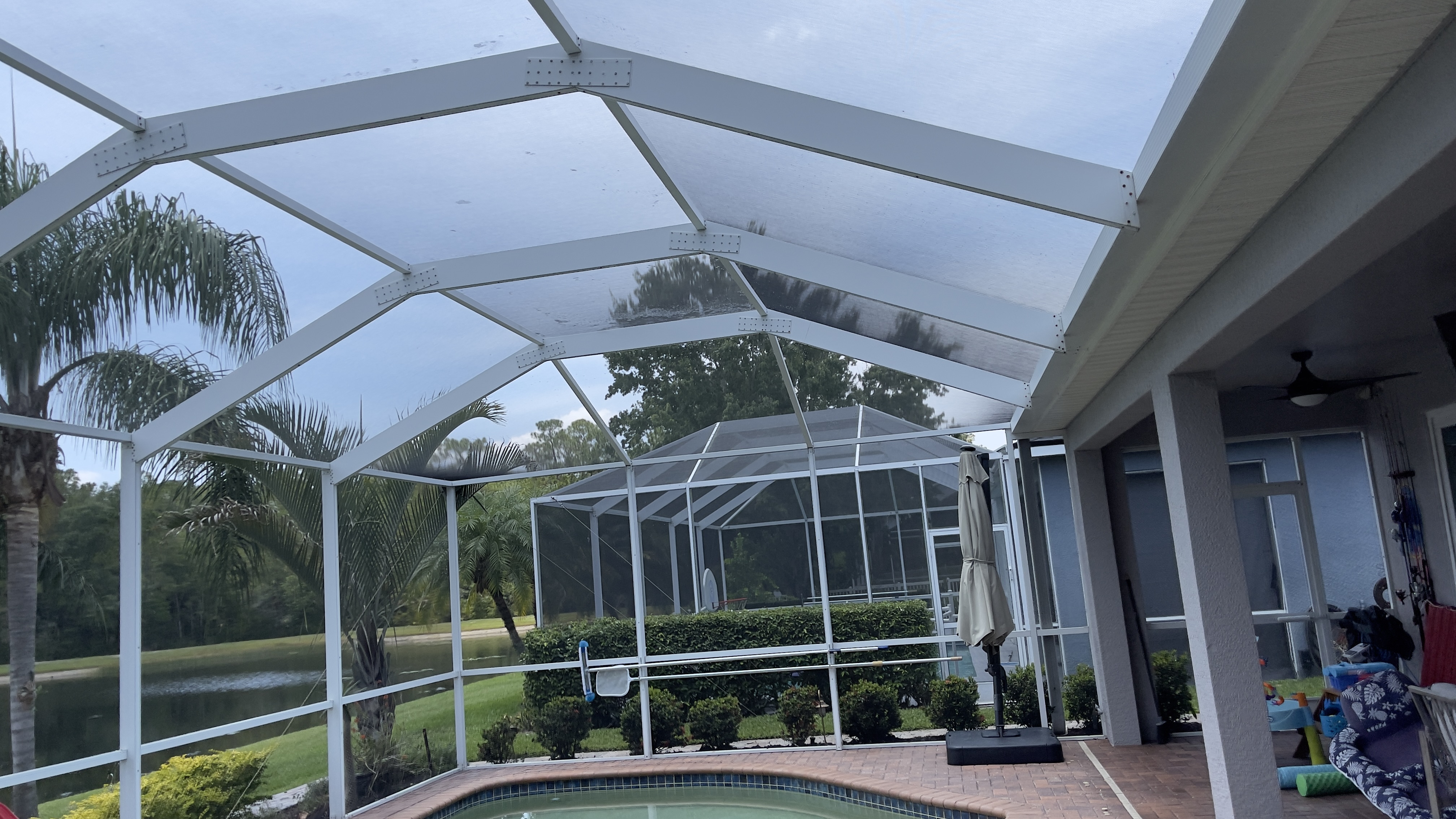 Pool cage structure in Tampa with screen and frame surfaces ready for cleaning