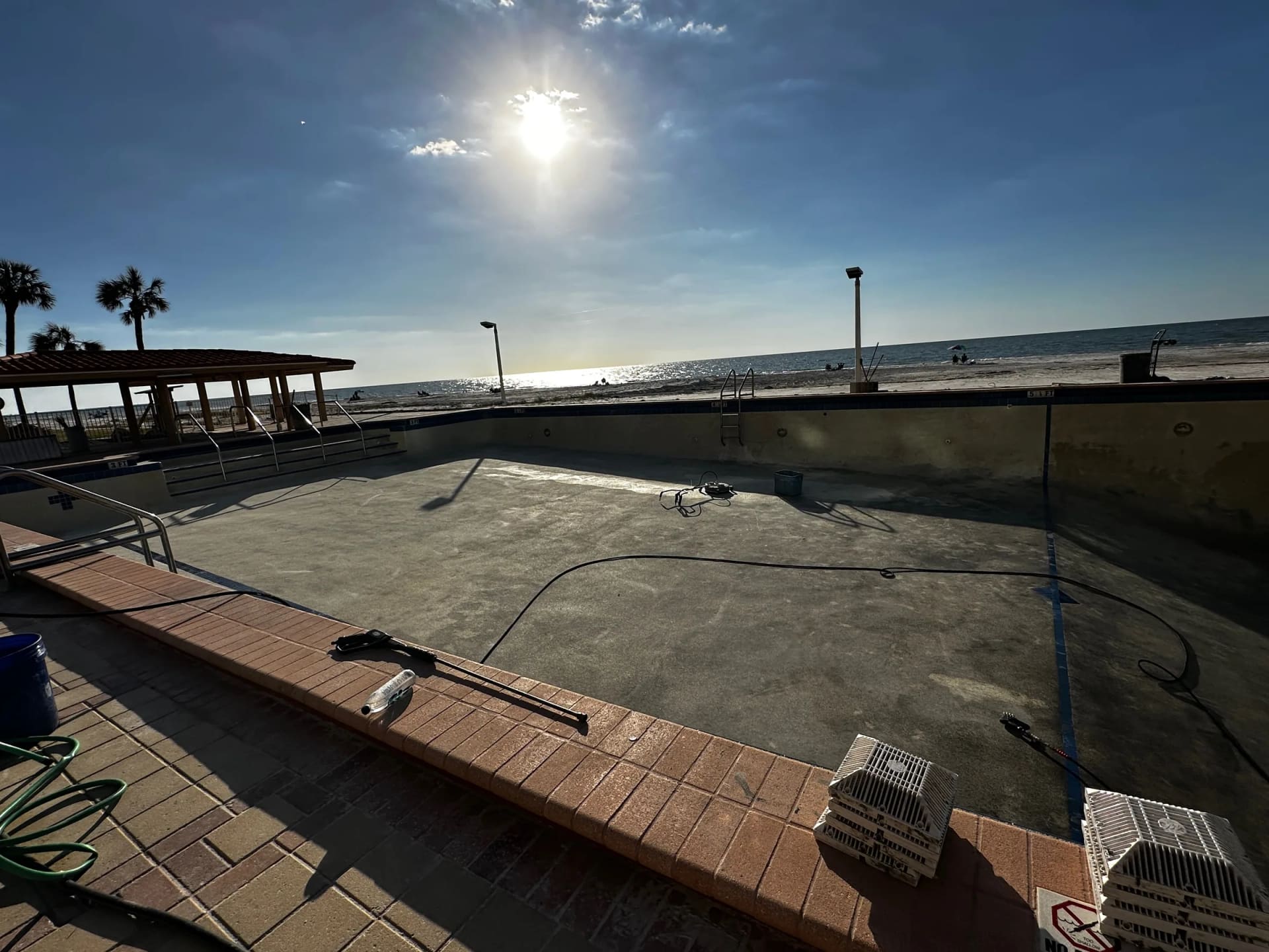 Regatta Beach Club pool area wide view during cleanup work