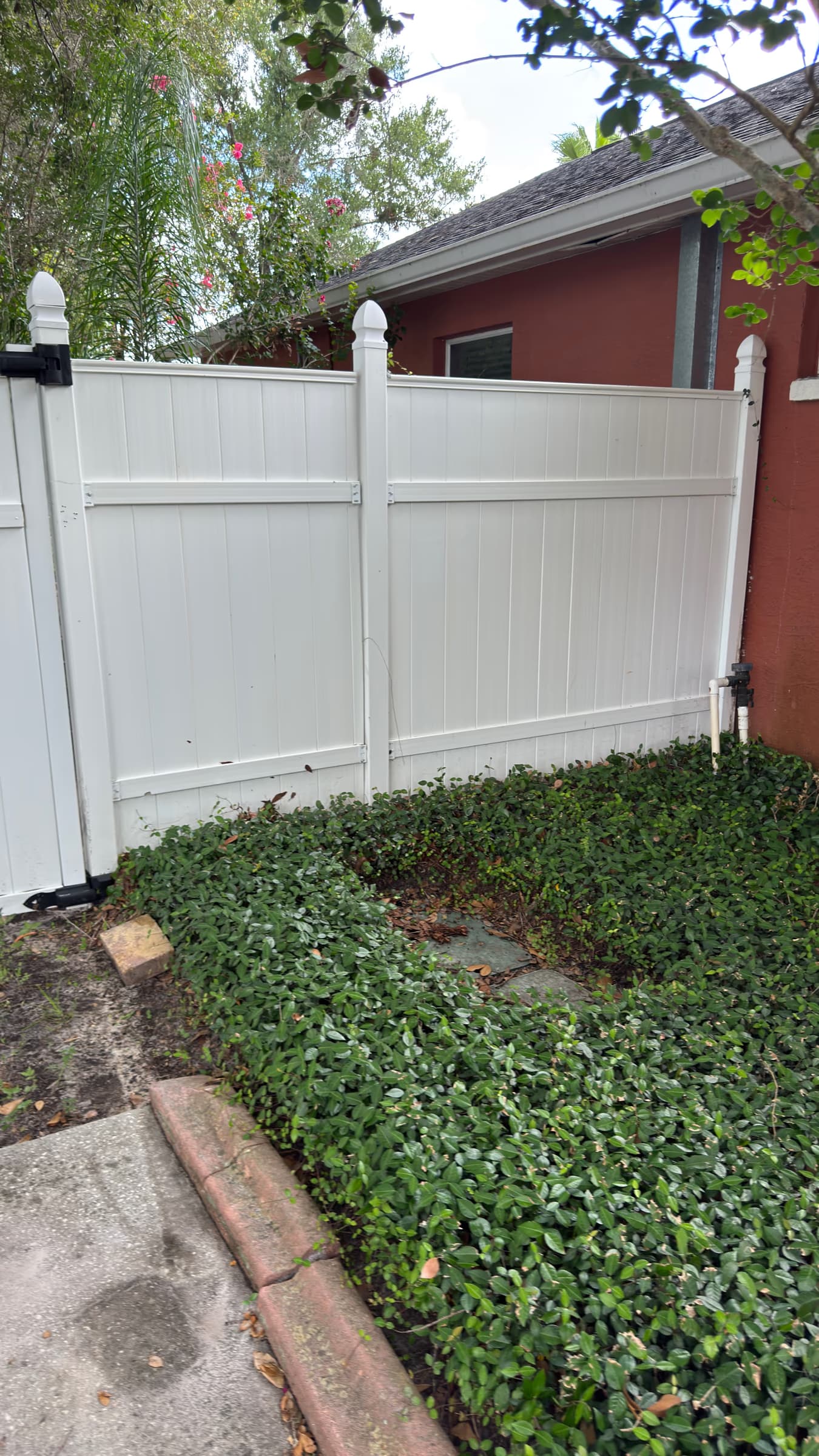 Privacy fence and nearby concrete cleaning example representative of Hudson backyard pressure washing work
