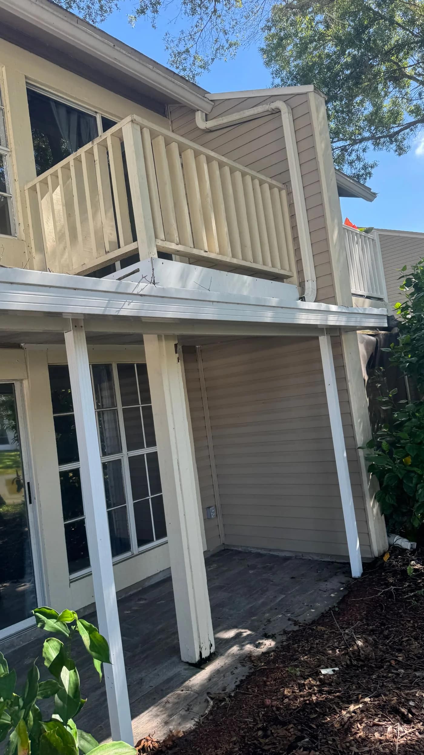 Gutter cleaning service in Tampa on a two-story home with visible roofline and gutter access