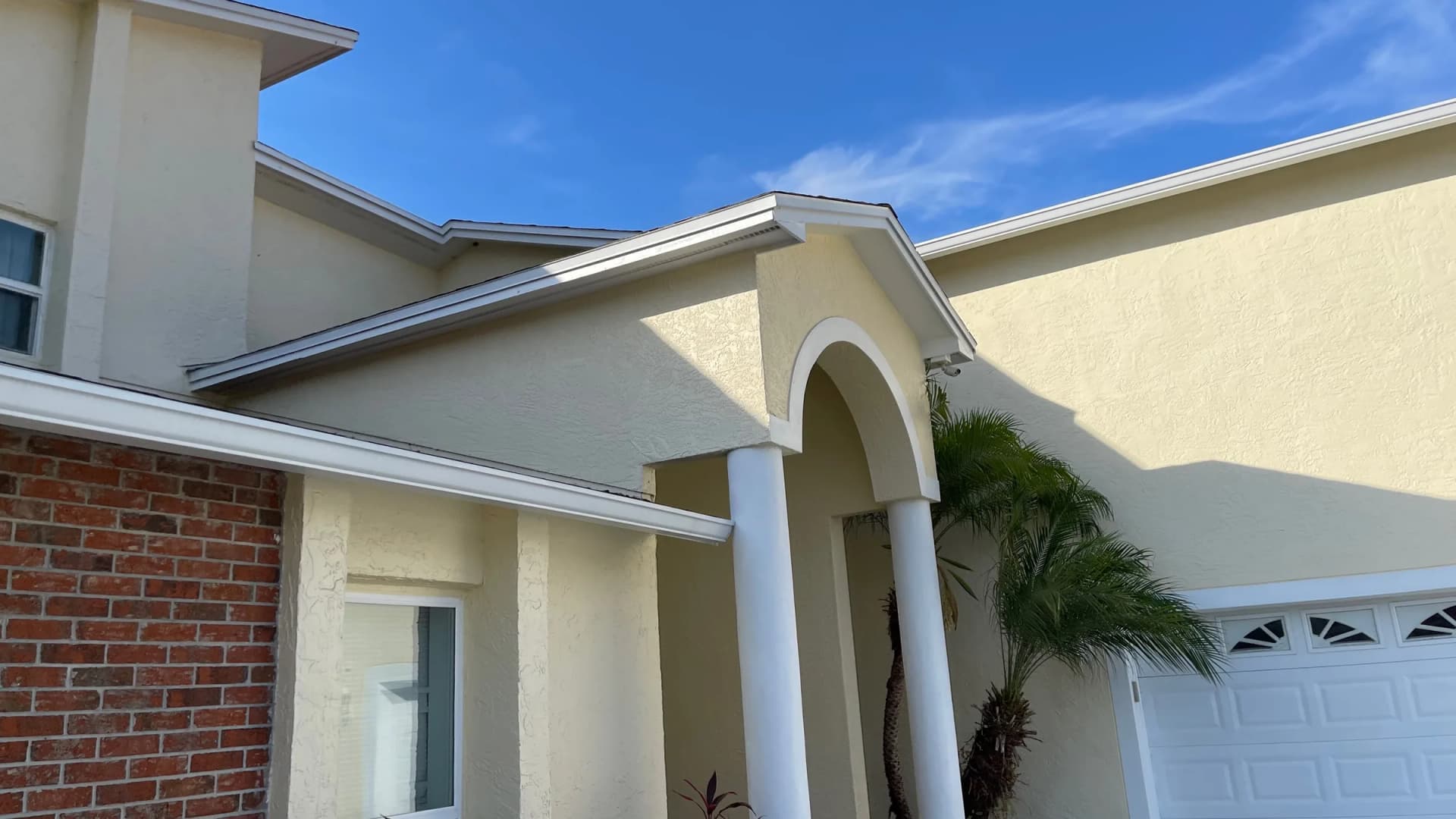 Freshly cleaned stucco, trim, and garage frontage ready for listing photos at a Tampa home