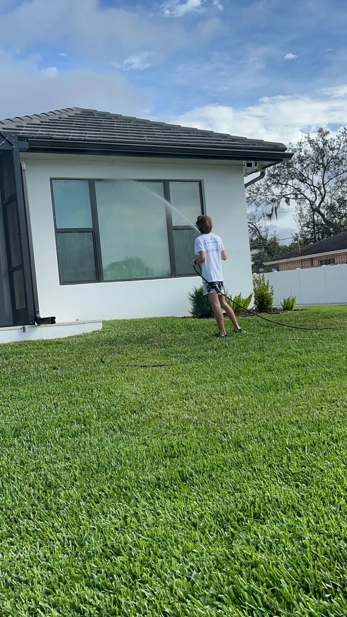 Soft washing service in Tampa with a low-pressure rinse on a residential exterior