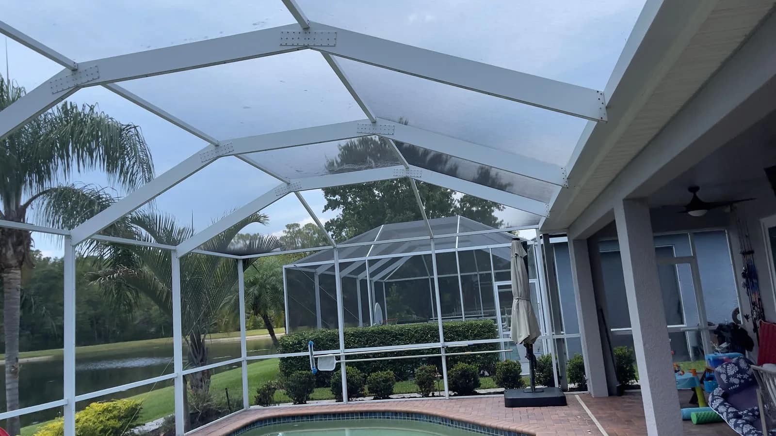 Pool cage structure in Tampa with screen and frame surfaces ready for cleaning